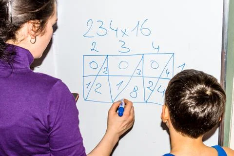 Mother teaching her son to math on white board Stock-Fotos