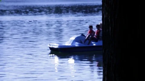 Mother with Three Kids in Paddle Boat Stock Footage