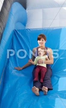 Mother with toddler on slide Stock Photos