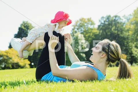 A mother training with baby on a summer day Stock Photos