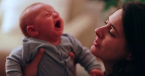 Mother trying to console crying newborn baby Video stock 118304697