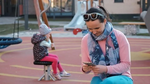 Mother Uses Smartphone Instead Plays with Child Stock Footage 154148335