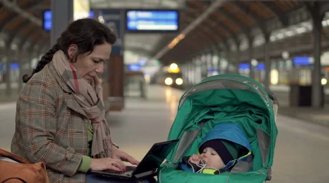 Mother using computer on station  Stock Footage 60663570