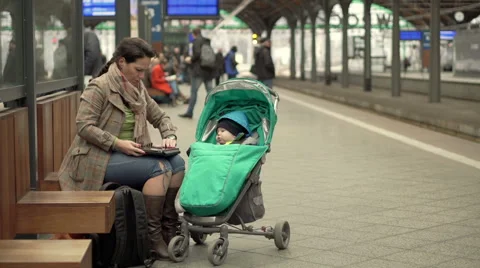 Mother using computer on station  Stock Footage 60663594