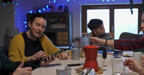 Mother using smartphone at breakfast table Stock Footage 326873801