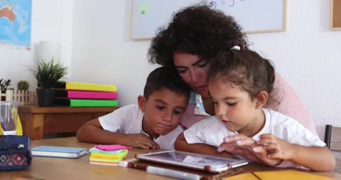 Mother using tablet with children at home Stock Footage 141051186