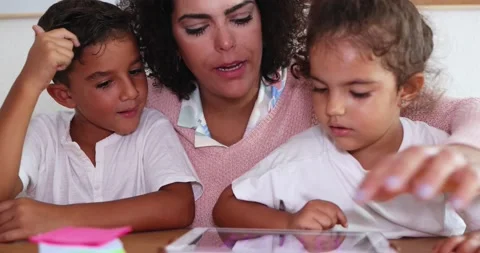 Mother using tablet with children at home Stock Footage 141051314