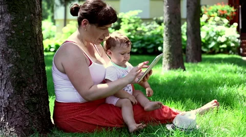 Mother using tablet with son Stock Footage 64947841