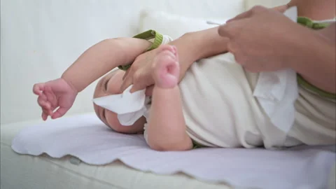 Mother is using a tissue paper to clean child nose Stock Footage 288005815