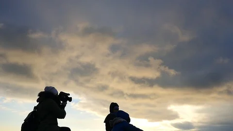 Mother with video camera and 2 small boys posing in it silhouettes Stock Footage 100717407