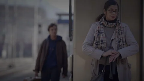 Mother Waiting for Son at Train Station Checking the Time to Consult a Stock Footage 272188377