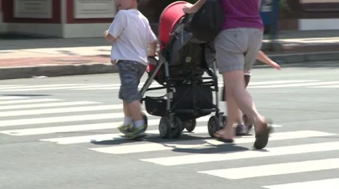 Mother walking across intersection. Stock Footage 8693950