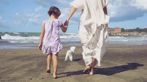 Mother walking hand in hand with little girl walking slow motion Stock Footage 80308256