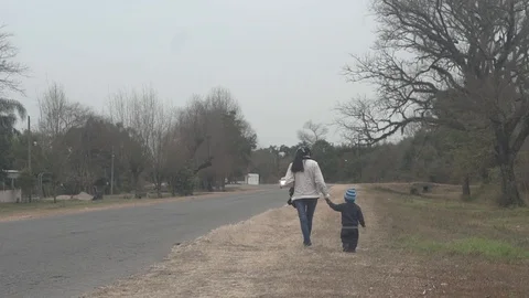  mother walks with her son on the side of the road Stock Footage 123799773