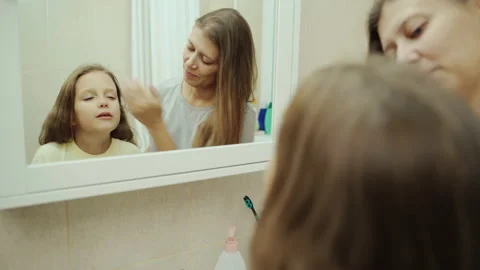 Mother Washes Small Child's Face With Water Video stock 143689112