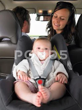 Mother Watching Baby In Car Seat