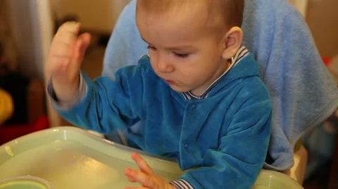 Mother wipes cloth after feeding the baby porridge Stock Footage 59338716