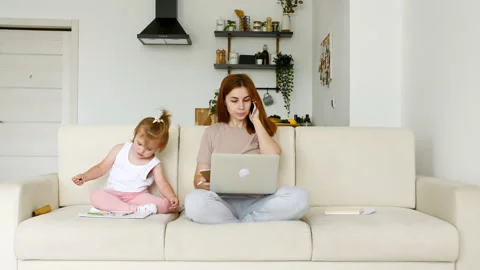 Mother working from home, having a work video call, phone call and child playing Stock Footage 162814746