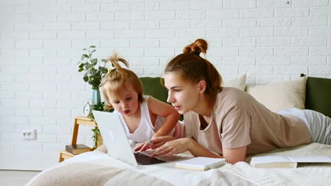 Mother working from home, having a work video call, while her child distracts Video stock 164287703