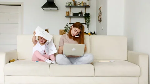 Mother working from home, having a work video call, phone call and child playing Video stock 166153614