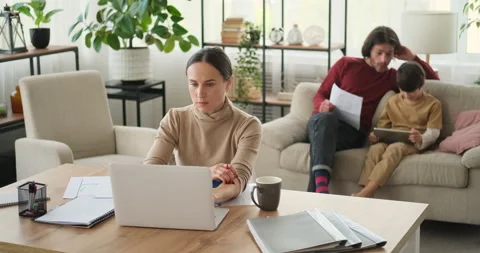 Mother working from home while father and son using digital tablet Stock Footage 145225705