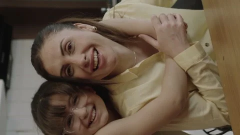 The mother works remotely with a computer at the dining table in the kitchen. Stock Footage 204713216