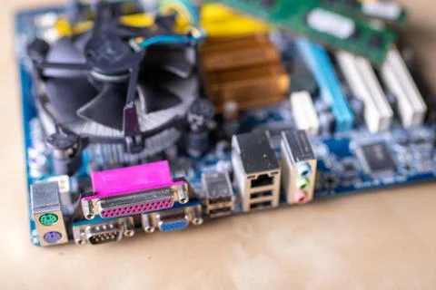 The motherboard and computer components. Computer accessories on a workshop t Stock Photos