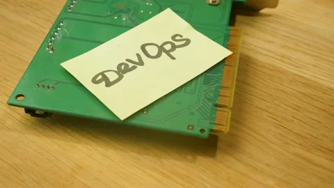 Motherboard and sticker devops rotate on wooden background, Stock Footage 155804553