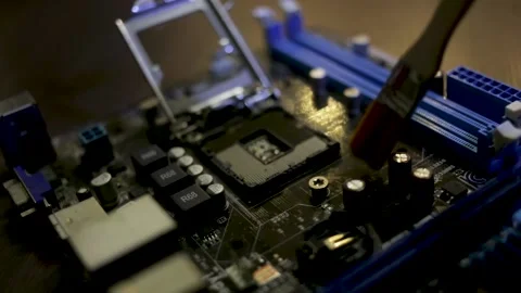 The motherboard of the computer is cleaned from dust with a brush Stock Footage 166806369
