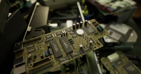 Motherboard on workbench surrounded by other electronic components in worksho イラスト素材