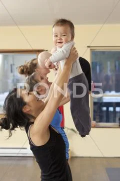 Mothers and babies taking yoga class Stock Photos