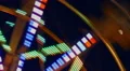 Motin Blurred Illuminated Ferris Wheel and Moon HD Footage