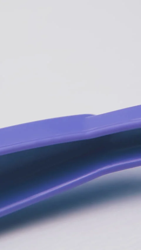 Motion above colorful disposable fork on light background Stock Footage 317384830
