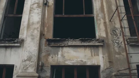 Motion up along abandoned building with rusty fire stairs Stock Footage 152218430