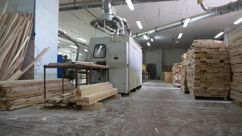 Motion along empty carpentry shop with boards and machines Stock Footage 141119354