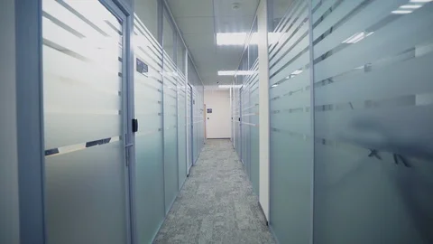 Motion along hallway between offices with glass walls Stock Footage 104839736
