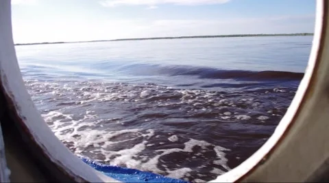 Motion along the river or lake on a boat, the view to the open porthole Stock Footage 51534162