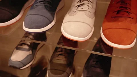 Motion along shelving with collection of new men sneakers Video stock 146874397