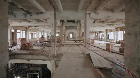 Motion along a spacious empty interior of a warehouse building with a concrete Video stock 264070834