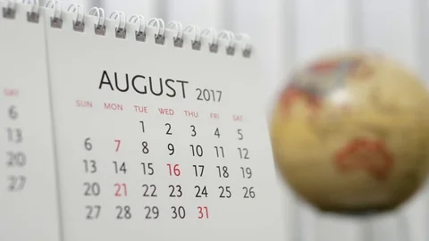 Motion of August 2017 calendar with blur earth globe turning background Stock Footage 70999041