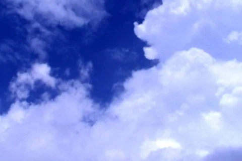 Motion background - white clouds flying on blue sky Stock Footage