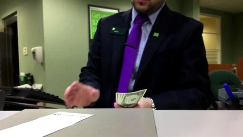 Motion of bank clerk counting US dollar for customer inside TD bank Stock Footage 73952687