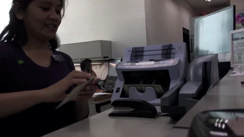 The motion of bank teller using machine to count money 스톡 동영상 276878693