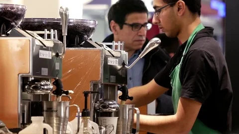 Motion of barista making coffee for customer at Starbucks store Stock Footage 73997452