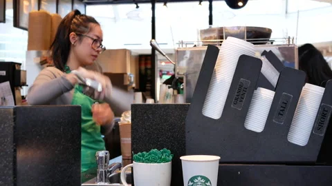 Motion of barista making coffee for customer at Starbucks store Stock-Footage 105441768