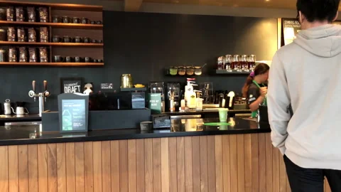 Motion of barista making coffee for customer at Starbucks store Stock Footage 112504265