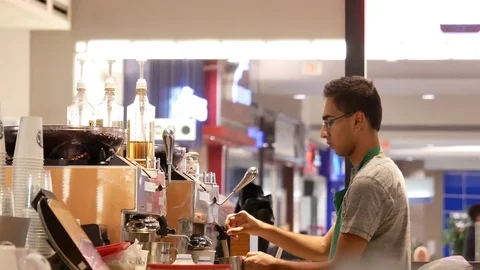 Motion of barista preparing coffee for customer at Starbucks store Stock Footage 80478057