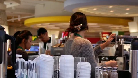 Motion of barista preparing coffee for customer at Starbucks store Stock Footage 81262782