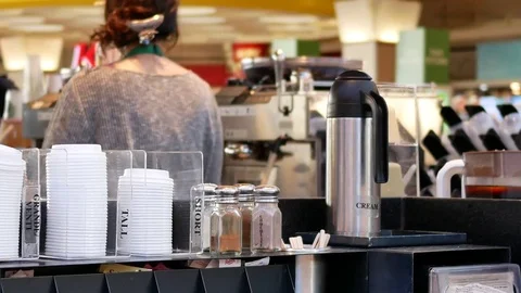 Motion of barista preparing coffee for customer at Starbucks store Stock Footage 83297026