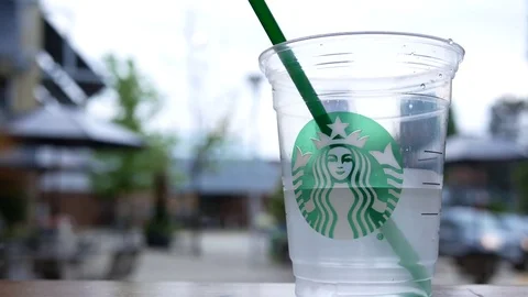 Motion of beverage on table at Starbucks store with blurred people Stock Footage 84037697